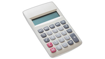 Calculator resting on knitting patterns, symbolizing the mathematical calculations often needed in machine knitting projects