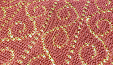 An example of machine-knitted thread lace fabric showing the delicate openwork effect created by combining a fine thread with thicker yarn, demonstrating how this technique mimics traditional lace patterns