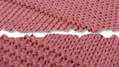 Close-up of machine-knitted fabric showing various garter stitch techniques and textural accents achieved on a knitting machine, contrasting with traditional stockinette stitch