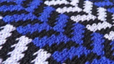 Close-up of a machine-knitted Fairisle pattern showing two-color stranded knitting