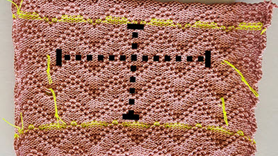 A machine-knitted tuck stitch pattern swatch with visible stitch markers, demonstrating proper gauge measurement techniques for textured patterns