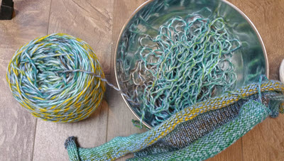 A bowl containing ripped-out yarn from a knitting project, curled in characteristic ripples from being previously knitted