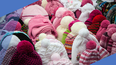 A collection of machine-knitted hats arranged to showcase various styles and techniques, from beginner-friendly to advanced designs