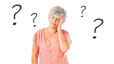 Frustrated woman holding her head in hands, surrounded by floating question marks, expressing confusion about machine knitting challenges