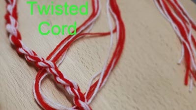 Demonstration of twisted cord creation showing loose yarn strands next to finished twisted cord