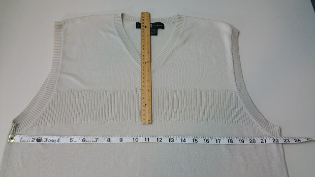 Measure the sweater flat in inches or cm.