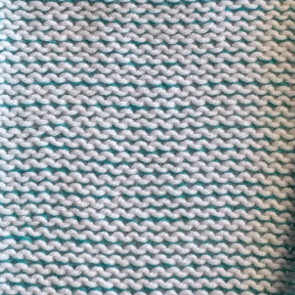 2 yarns of equal weight - plated - White in #2 slot - Teal in #1 slot Purl side