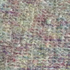 Textured yarns plated. Notice how the "hairy" yarn overpowers the other yarn. Purl side.