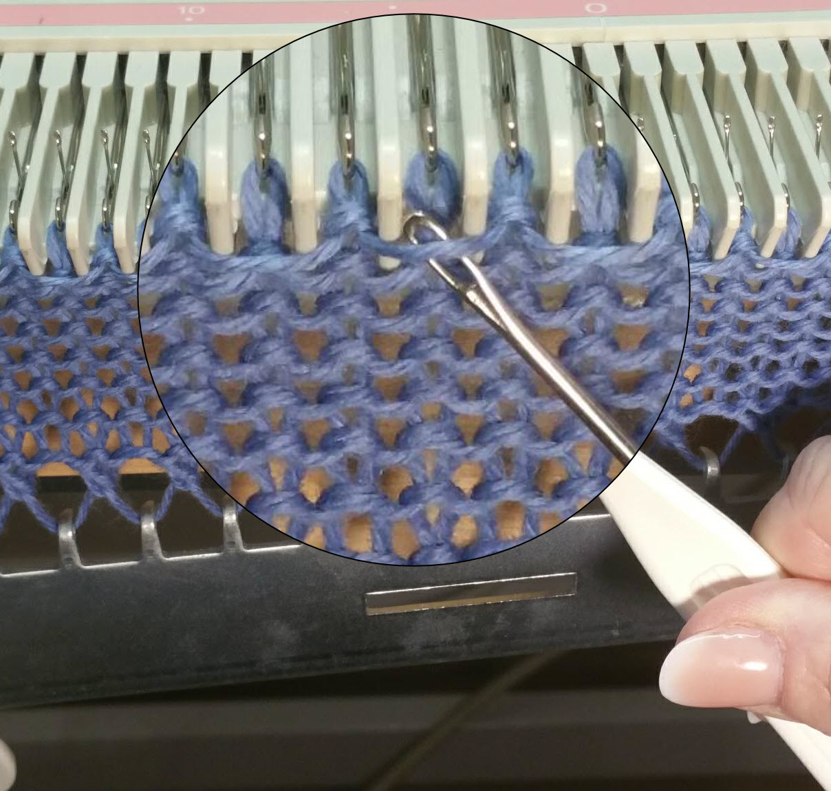 Yarn strand carried under slipped needles