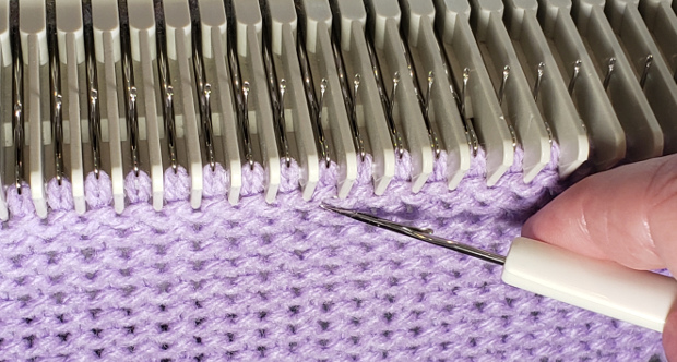 Insert the latch tool in the loop of the stitch in the row below