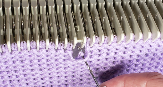 Un-knit (loosen) the stitch and free the strand