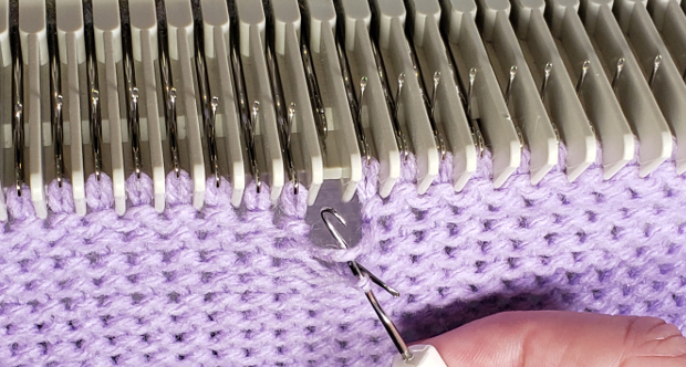 Place the stitch that is on the tool behind the latch and place the un-knit strand in the hook of the tool
