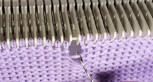 Pull back on the tool, closing the latch over the strand