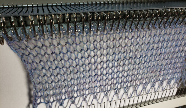 A fine coned yarn (2/8) knit loosely at tension 9 creates open, lacy knitting.